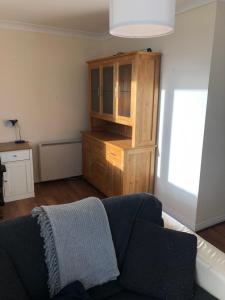 ein Wohnzimmer mit einem Sofa und einem Holzschrank in der Unterkunft Connolly Private Guest House in Dublin