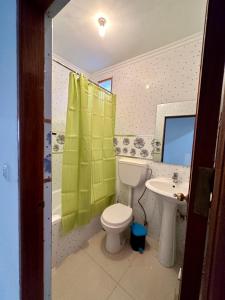 a bathroom with a toilet and a sink at Cidade Velha - Cathedral view - 1Bdr Apart - 1 in Cidade Velha