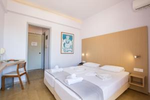 A bed or beds in a room at Atlantis Hotel
