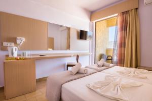 A bed or beds in a room at Atlantis Hotel