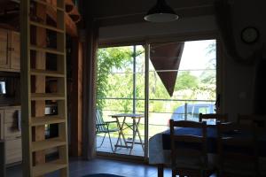 a room with a glass door leading to a patio at Les Glycines de Soubize in Lablachère