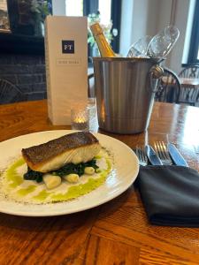 a fish dish on a plate on a table at The Fishmongers Tavern in Sheringham