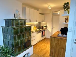 a large kitchen with white cabinets and a counter at The Peaceful Garden Stay & Free Parking in Salzburg