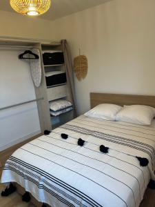 a bedroom with a bed with black cats on it at Charmant Cocon en duplex avec jardin in Noisy-le-Sec