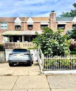 a car parked in front of a brick house at LGA Airport near, Studio walk in bsmt Apt in a Private House! in East Elmhurst
