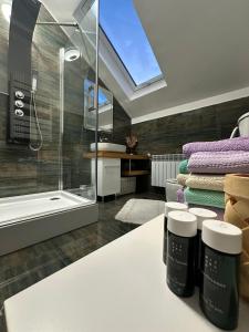 a bathroom with a shower and a sink with towels at Attic 33 in Câmpulung Moldovenesc