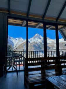 a room with a view of snow covered mountains at Planet kazbegi in Stepantsminda