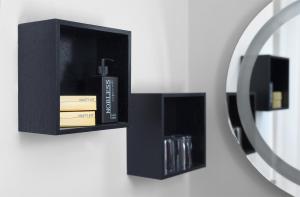 a black shelf with a bottle of soap and books at TRIP INN Kaiser Hotel & Restaurant Heidelberg-Schriesheim in Schriesheim