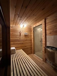 a sauna with a bench in a wooden room at Attic 33 in Câmpulung Moldovenesc