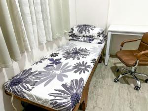 a hospital room with a bed and a chair at Affordable Condo beside Ayala Mall Bacolod! in Bacolod