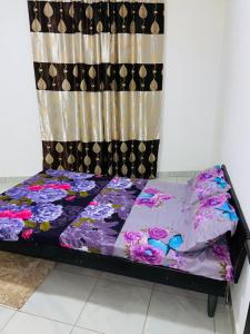 a bed in a room with a curtain at H&M Penthouse in Serekunda