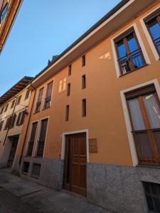 um edifício laranja com uma porta e janelas em Loft64 em Alba