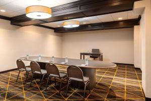 a conference room with a large table and chairs at AmericInn by Wyndham Rochester Near Mayo Clinic in Rochester