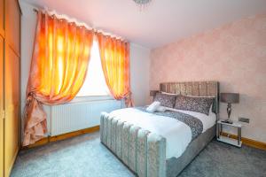 1 dormitorio con 1 cama y una ventana con cortinas de color naranja en *RC98BL* For your most relaxed & Cosy stay + Free Parking + Free Fast WiFi * en Farnley