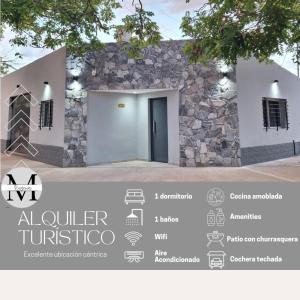 a house with a stone wall and a door at Departamentos Muy Eugenia in San Rafael
