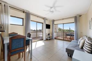 a living room with a couch and a table at House Amendoeiras in Vilamoura
