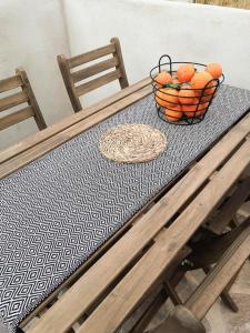 a table with a bowl of oranges on it at Ronda Center Apartments with Pool in Ronda
