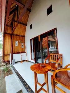 een kamer met een tafel en stoelen in een kamer bij Meket Bungalows in Nusa Penida