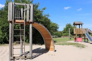 a playground with a wooden slide and a ladder at Ferienhaus Winnetou Im Abendrot 127 in Waldbrunn