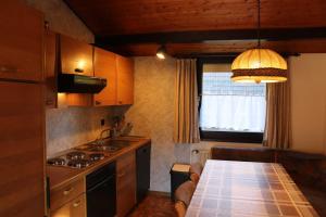 a kitchen with a table and a sink and a window at Ferienhaus Robinson Im Abendrot 123 in Waldbrunn