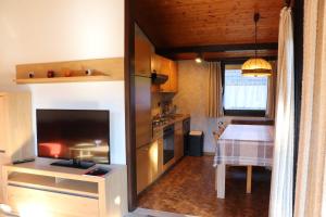 a kitchen with a table and a dining room at Ferienhaus Robinson Im Abendrot 123 in Waldbrunn