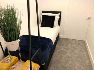 a bedroom with a bed and a potted plant at The Hughenden Townhouse / Free Parking / Wifi in Leicester