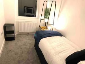 ein kleines Schlafzimmer mit einem Bett und einem Spiegel in der Unterkunft The Hughenden Townhouse / Free Parking / Wifi in Leicester