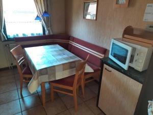 a kitchen with a table and a microwave at Ferienhaus Robinson Romantikpfad 164 in Waldbrunn