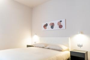 Postel nebo postele na pokoji v ubytování Palmanova Suites