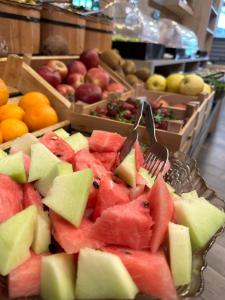 a bunch of fruit on a table with forks at Mai İnci Otel in Antalya