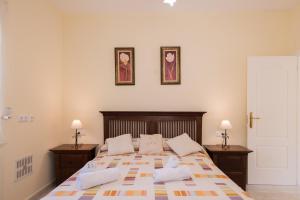 a bedroom with a large bed with two night stands at Villa Amelia - PlusHolidays in Ifach +13 photos