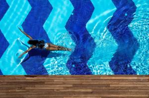 a person swimming in a swimming pool at Rixos Premium Dubrovnik in Dubrovnik