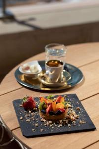 a plate of food on a table with a cup of coffee at Rixos Premium Dubrovnik in Dubrovnik