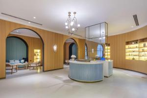 a lobby with a reception counter and a living room at Rixos Premium Dubrovnik in Dubrovnik