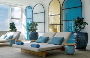 a living room with a couch and some windows at Rixos Premium Dubrovnik in Dubrovnik