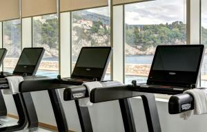 a row of laptops on a treadmill in a gym at Rixos Premium Dubrovnik in Dubrovnik