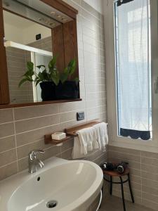 a bathroom with a white sink and a mirror at Locanda Caffe Sport in Volpago del Montello