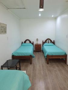 a room with two beds and a table in it at JAP in Río Gallegos