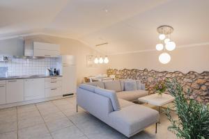 a living room with a couch and a kitchen at Apartments Lina in Vrh