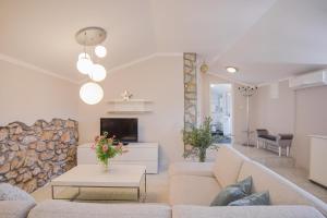 a living room with a couch and a fireplace at Apartments Lina in Vrh