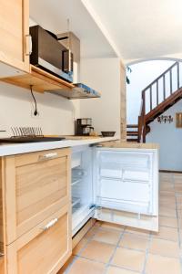 a kitchen with an open refrigerator and a staircase at Casa Emblemática Isabel in Santa Cruz de la Palma