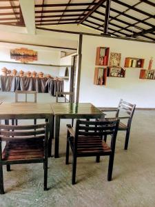 a wooden table and chairs in a room at coco cabana in Bentota