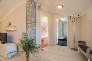 a hallway with a living room with a couch and a television at Apartments Lina in Vrh