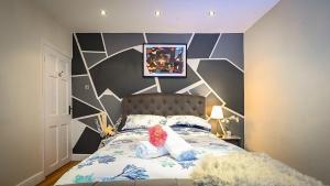 a bedroom with a bed with a teddy bear on it at Urban Bliss 2BR Enfield Hideaway - Cosy Spot - Free Parking & Wi-Fi in Enfield