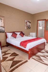 a bedroom with a large bed in a room at The Stand Leisure Hotel in Nairobi