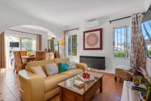 a living room with a couch and a table at Villa Anais - PlusHolidays in Calpe