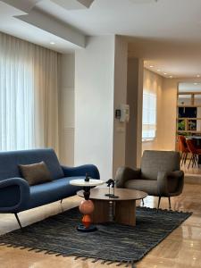 a living room with a blue couch and a table at Misk Villa - Boutique Hotel & Spa in Sidi Bou Saïd