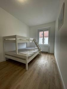 a white room with a bunk bed in it at Mulhouse, Urban Family Nest in Mulhouse