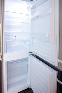 an empty refrigerator with its door open in a kitchen at Broggi 22 in Milan