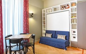 a living room with a blue couch and a table at Broggi 22 in Milan +52 photos